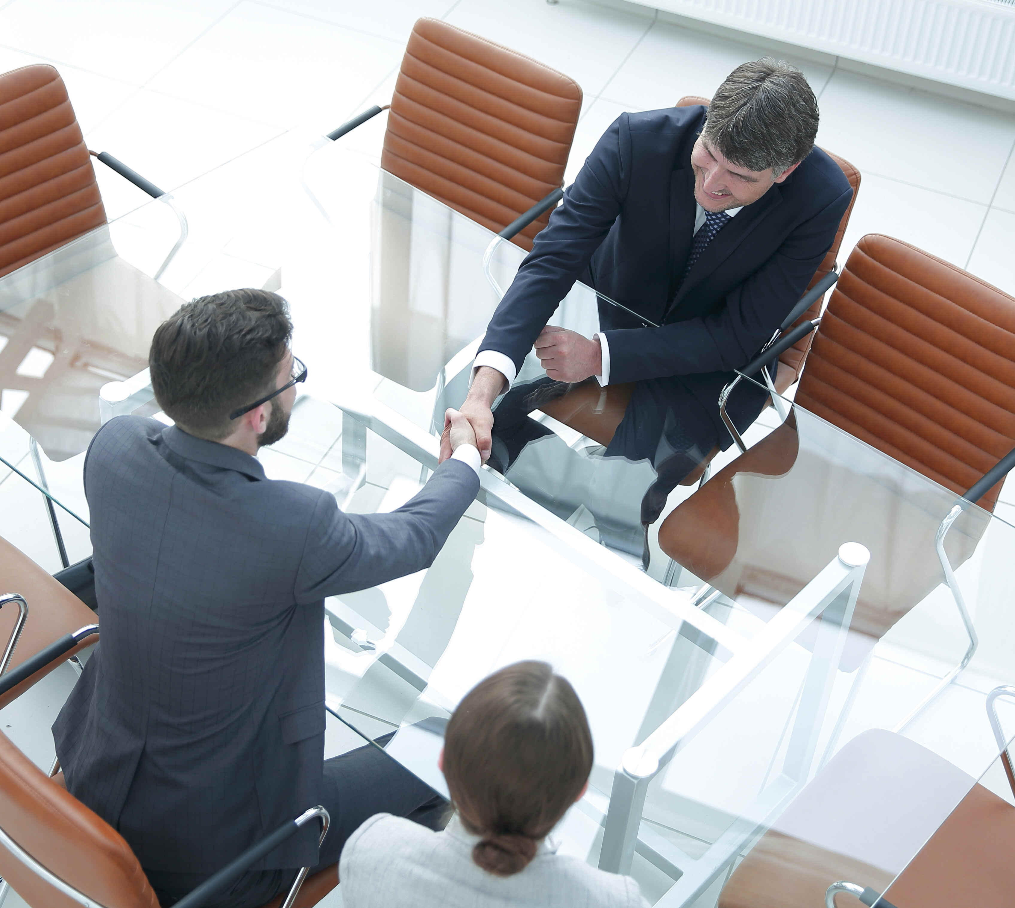 View from above . Handshake of financial partners after negotiations View from above . Handshake of financial partners after negotiations